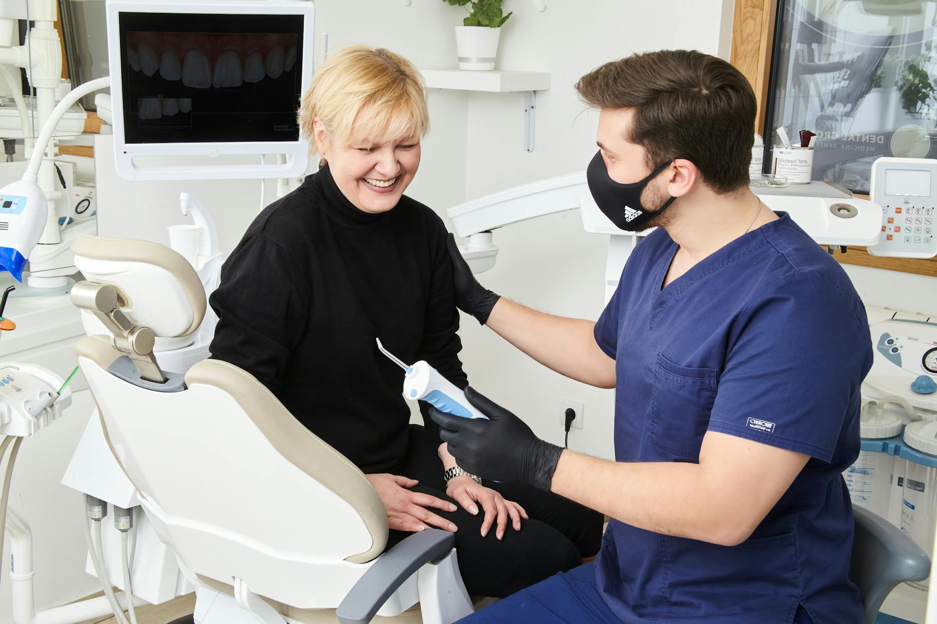 Dentist consulting with patient